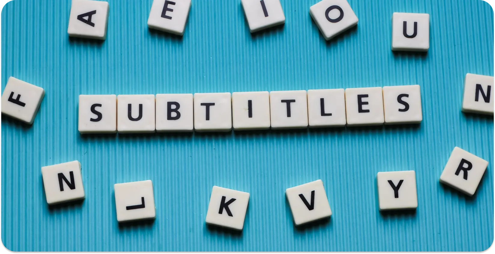 Alphabet tiles on a blue background spelling 'SUBTITLES' amid scattered letters.